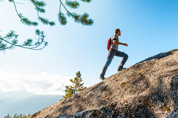Challenges, success and accomplishment in business and life. Aspirational conceptual image of fit male hiker man climbing and hiking steep mountain in uphill climb © Maridav