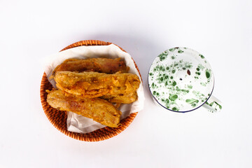 Fried bananas and small vintage cups white with green patterns. isolated on white background