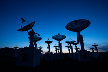 The silhouette of a radio telescope