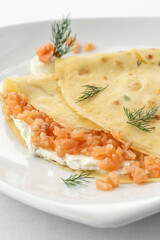 smoked salmon and sour cream crepe pancake on white background