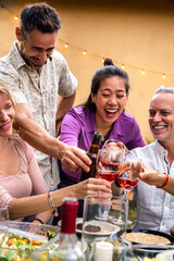Vertical portrait of asian young woman toasting with wine, celebrating with friends, laughing....