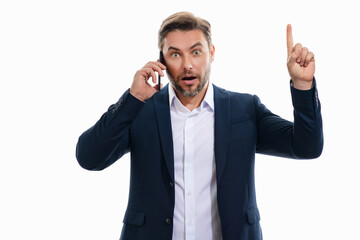 Portrait of a surprised business man in suit using mobile phone. Caucasian man using smart phone cellphone for calls, social media, mobile app. Online chatting. Guy talking on the phone.