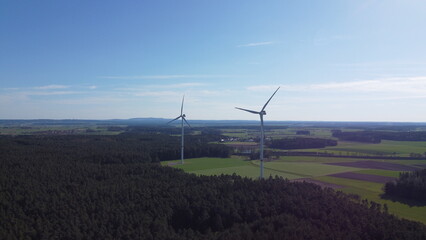 Fototapeta na wymiar Wind turbines in a farm field up close with a drone point of view. Over 100 meters tall.