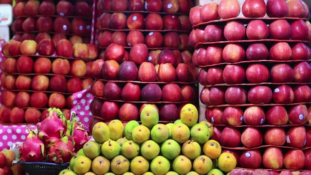 Bright Red apples, Mangoes and Dragon Fruits for sale in a Indian Fresh Fruit Market. Mysuru, Karnataka, India. 