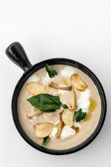 gourmet cream of mushroom soup in black ceramic bowl