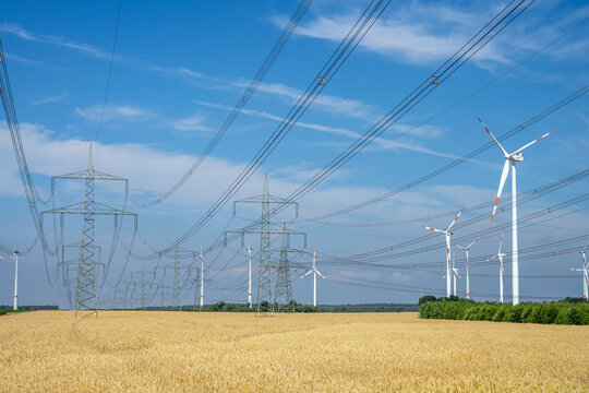 Pylons, power lines and wind turbines seen in an agricultural area in Germany