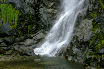 Obraz premium Naga falls is a beautiful waterfall situated near Lachung in North Sikkim, India. Situated on Gangtok-Chungthang road, it is one of the waterfalls in Sikkim and among the must visit places in Lachung.
