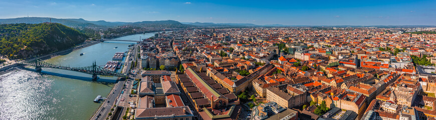 Fototapeta na wymiar Budapest, Hungary - Aerial panoramic view of capital of Hungary on a sunny summer day. This view includes Liberty Bridge, Gellert Hill, Buda Castle, city centre and Puskas Arena with clear blue sky