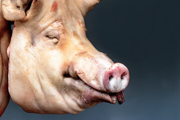 Pig's head in a butcher's shop. Sale of meat and semi-finished products. Pork.