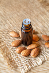 Almond essential oil in a small bottle. Selective focus.