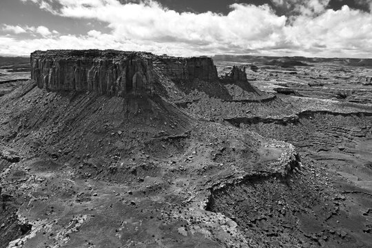 A viewpoint on the beautiful massive canyons of the Canyonlands National Park close to Moab in Utah, blue sky with clouds, amazing nature, dramatic clouds, black and white photography