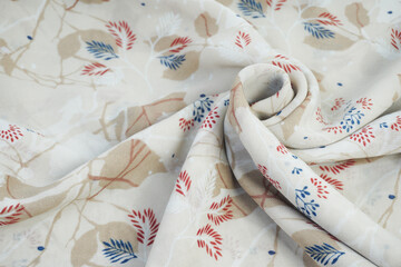 wavy and folded fabric patterned with leaves
