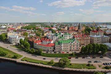 Fototapeta na wymiar Panoramic view of the central part of the city from the tower of St. Olaf Vyborg Castle, Leningrad region, Saint-Petersburg, Russia. Sunny summer day
