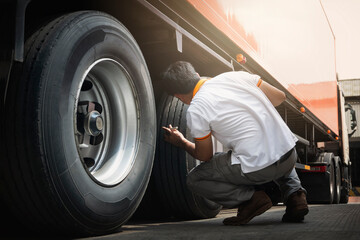 Fototapeta na wymiar Truck Drivers Checking the Truck's Safety of Truck Wheels Tires. Auto Mechanic. Truck Inspection Safety Driving. 