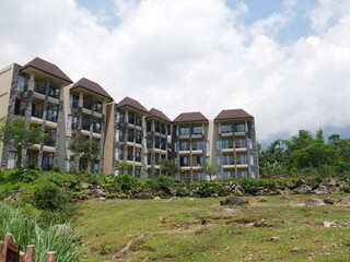 A building with many balconies and grass