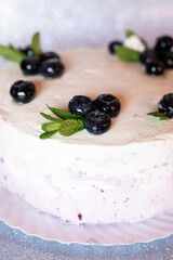 Cake decorated with fruits and chocolate on top.