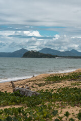 landscape of a typical far north Queensland beach. island and mountains in the background