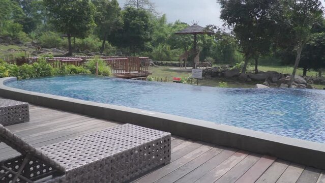 A pool with a wooden deck and outdoor view