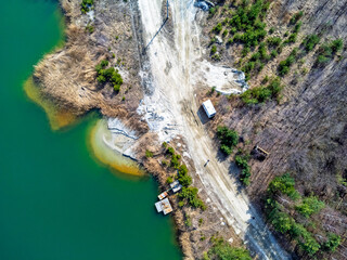 Aerial view landscape. Green water, factory, mining, sand. Photo from a drone.