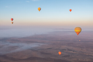 Gorgeous aerial view of hot air balloons flying over the Marrakech desert