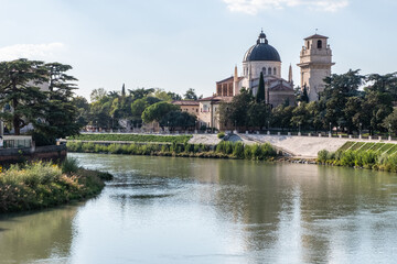 The calm waters of the Adige river cross the ancient city of Verona