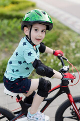 Boy in helmet with bicycle outdoor