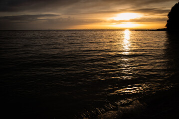 Lapping waves and setting sun