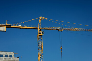 construction tower crane against blue sky