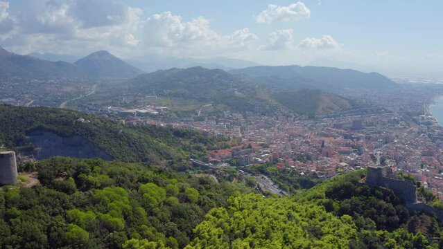 4k drone forward video (Ultra High Definition) of Bastiglia tower and Arechi Castle. Picturesque morning cityscape of Salerno town, Italy, Europe. Traveling concept background.