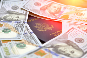 US passports in a pile of US dollar banknotes. US document.