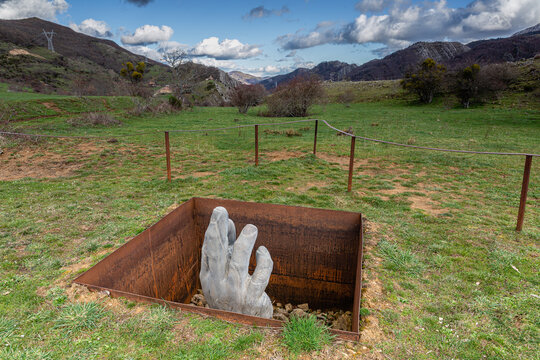 Geras de Gordon, Leon, Spain; 03-18-2023; Celorium Path. Huge hand carved in marble in a mountain meadow.