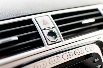 Modern car interior, black perforated leather, aluminum, details controls.