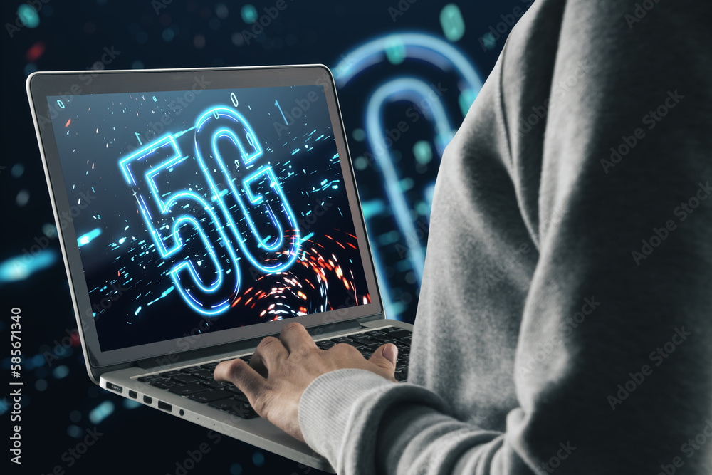 Poster Close up of hands using laptop with 5G icon on screen and on blurry dark background. Internet, 5G network connection and speed concept.