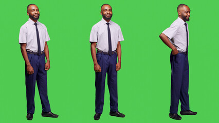 African american businessman posing in studio over full body greenscreen backdrop, feeling confident wearing formal business suit on camera. Male company employee feeling positive. © DC Studio