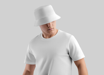 Mockup of a white panama for protection from the sun, a hat on a young man in a t-shirt, clothing for design, branding, advertising.