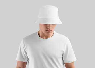 Mockup of a white panama for a man in a t-shirt, a spring, summer accessory isolated on the background.