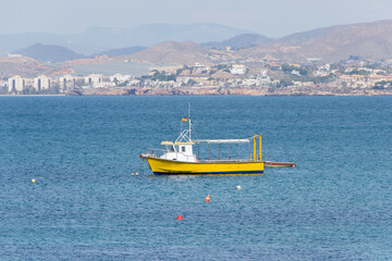 Obraz premium Spanish flag boat sailing in the Mediterranean