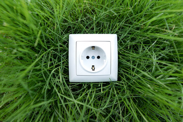 White electrical outlet on green grass