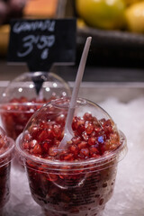 Pomegranate grains in a plastic cup in a marketplace