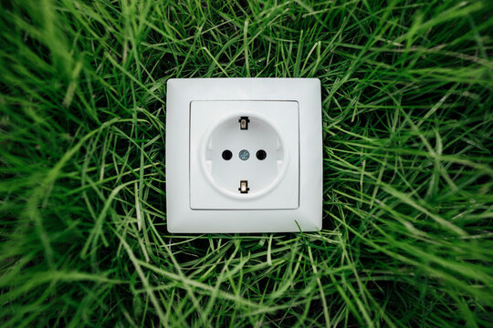 White electric socket on grass