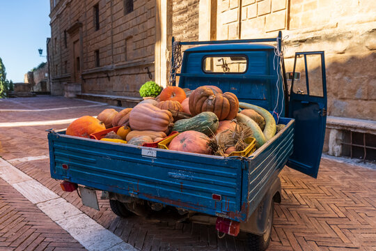 Van transporting heap of pumpkins
