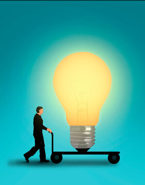 Businessman pushing large illuminated light bulb on trolley