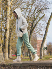 young beautiful hipster woman walking in the city street, fashion urban style