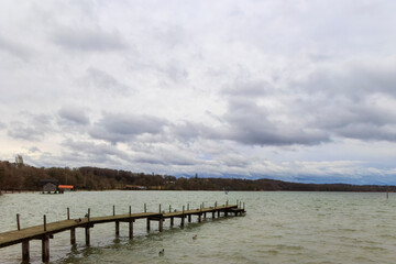 Fototapeta premium Boat jetty in Stegen am Ammersee on a cold windy day with cloudy sky