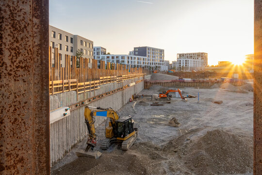 Backhoes collecting mud at construction site