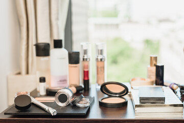 Different makeup products and accessories on table in modern beauty salon