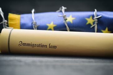 European Union flag, barbed wire and Immigration Law, migration to European Union concept