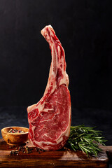 Raw Tomahawk beef steak and spices