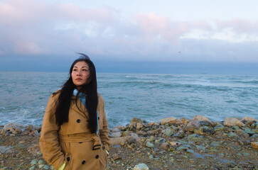 Dramatic portrait of a girl by the sea in winter