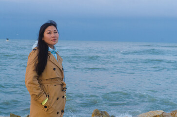 Dramatic portrait of a girl by the sea in winter